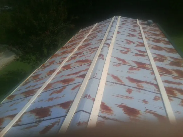 Rusted metal roof panels with new wood purlins before replacement — Storm Damage Roof Repair in Mc Leod by Roofing Brothers